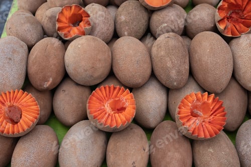Preview: Mamey Sapota fruit whole and sliced on display at a market in Oaxaca, Mexico