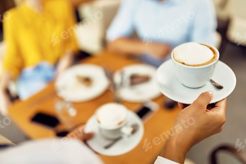 Preview: Close-up of waitress serving coffee in a cafe.