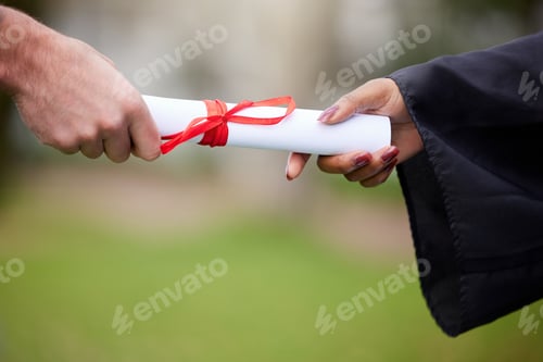 Preview: Closeup shot of an unrecognisable graduate receiving their certificate on graduation day