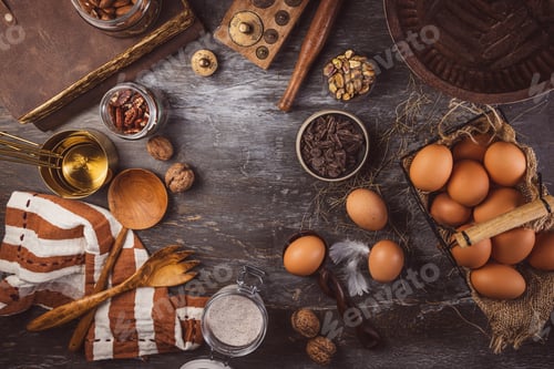 Preview: Assorted baking ingredients on wooden vintage table, in brown tone