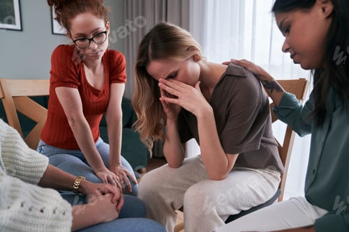 Preview: Group of women on group psychotherapy consoling a broken woman