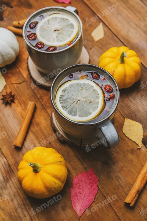 Preview: Warm mugs of spiced drinks with lemon, berries, and cinnamon sticks