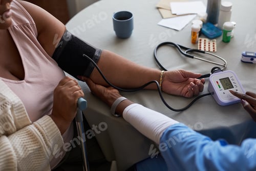 Preview: Black Woman with Disability Having Blood Pressure Checked