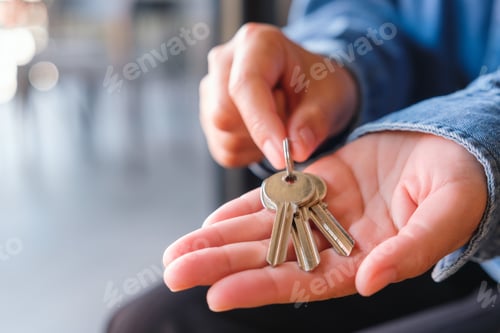 Preview: Closeup image of a woman holding the keys for real estate concept