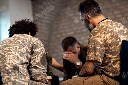 Preview: Group of diverse veterans talking during PTSD support group.