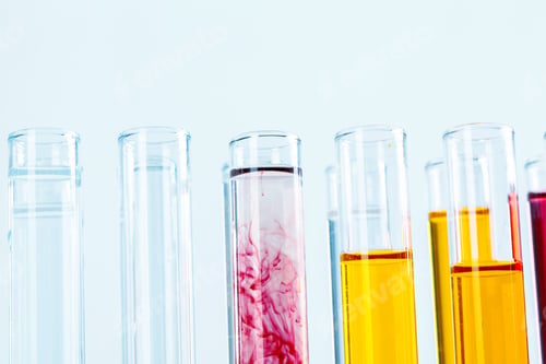 Preview: Different laboratory glassware with colored liquids close up