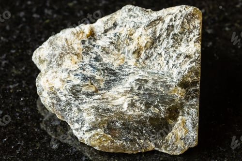 Preview: sample of raw dark labradorite mineral on black
