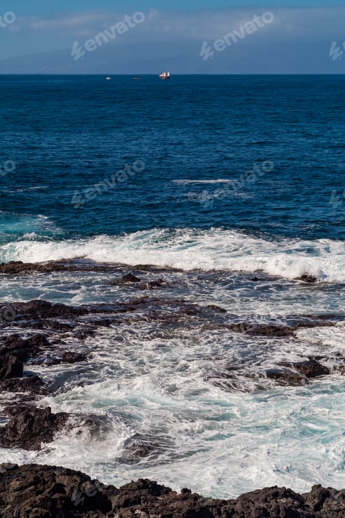 Preview: beautiful view on ocean water and black lava sand