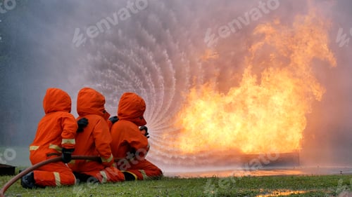 Preview: Firefighter fighting with flame using fire hose chemical water foam spray engine