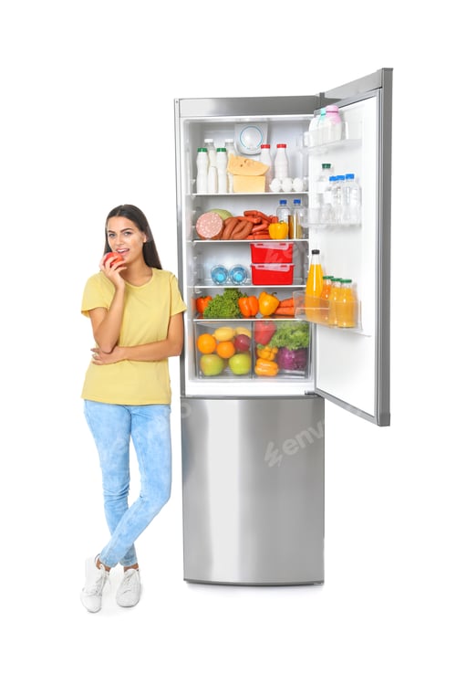 Preview: Young woman eating apple near open refrigerator on white background