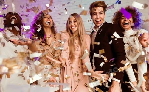 Preview: Joyful Diverse Friends Having Fun Standing Under Falling Confetti Indoor