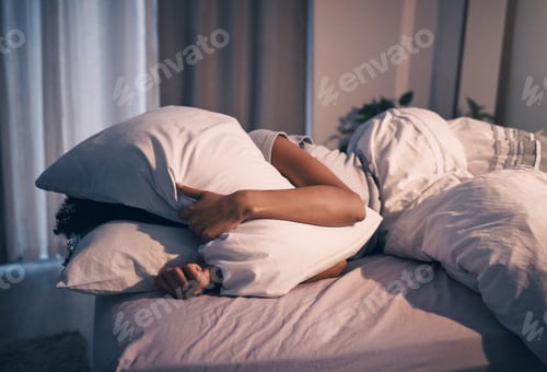 Preview: Bed, insomnia and woman with pillow on face, tired and frustrated with stress, nightmare or dream.
