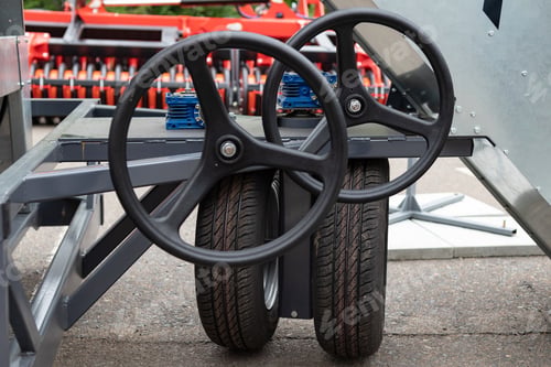Preview: Hand of farmer holding steering wheel of tractor in farm