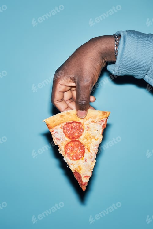 Preview: Male Hand Holding Slice of Pizza