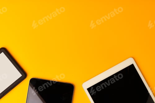 Preview: Digital tablet on yellow studio background top view