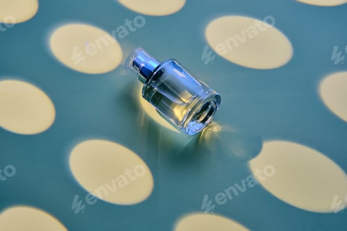 Preview: A bottle of perfume on a blue background in a yellow oval.
