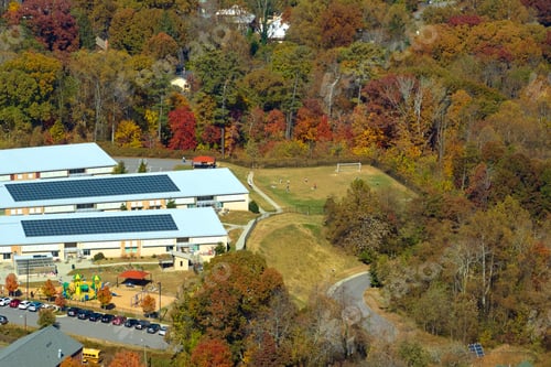 Preview: Roof of american school building covered with photovoltaic solar panels