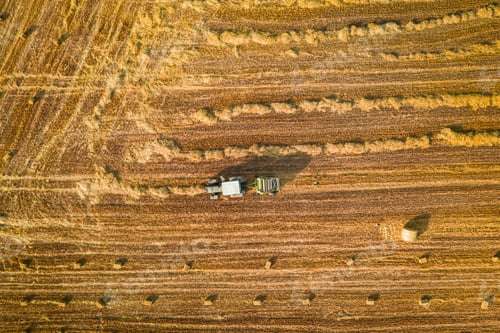 Preview: Tractor with round baler on fields, aerial view