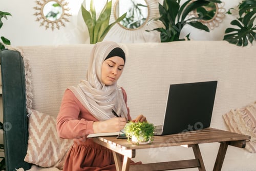 Preview: Woman in Headscarf Working at Home on Laptop