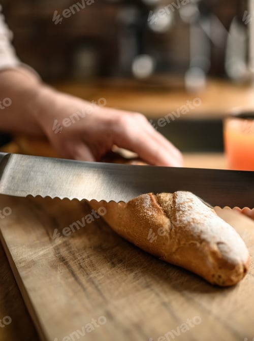 Preview: Girl hand cut french baguette with knife