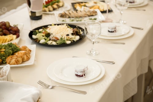 Preview: Nicely decorated banquet table with a variety of snacks and sandwich appetizers