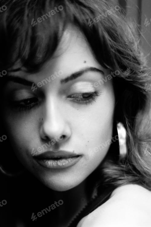 Preview: Monochrome head-shot of young woman looking away.