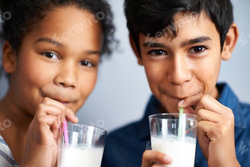 Preview: Calcium for healthy bones. A brother and sister drinking milk together.