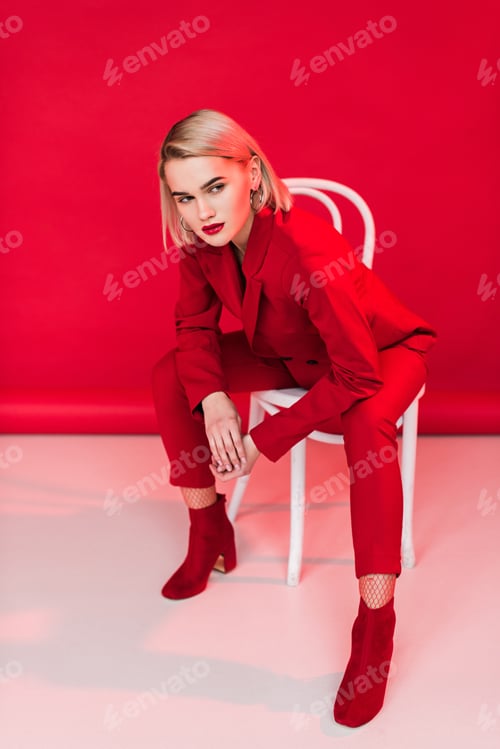 Preview: fashionable elegant girl posing in red suit, on red