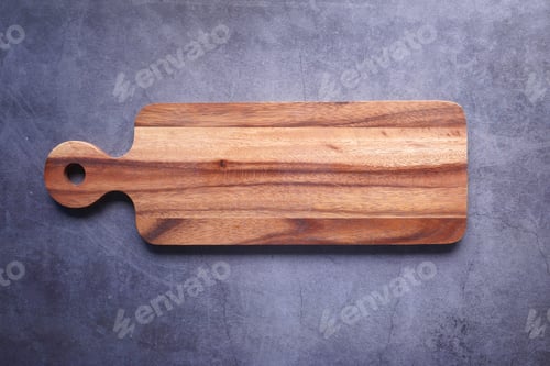 Preview: Top view of wooden chopping board on gray background .