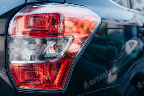 Preview: close up view of clean, polished rear lamp of modern automobile