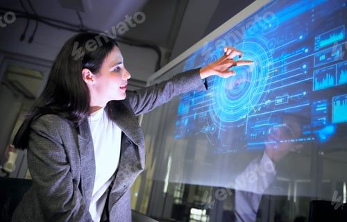 Preview: Woman interacts with digital interface in office during evening work session