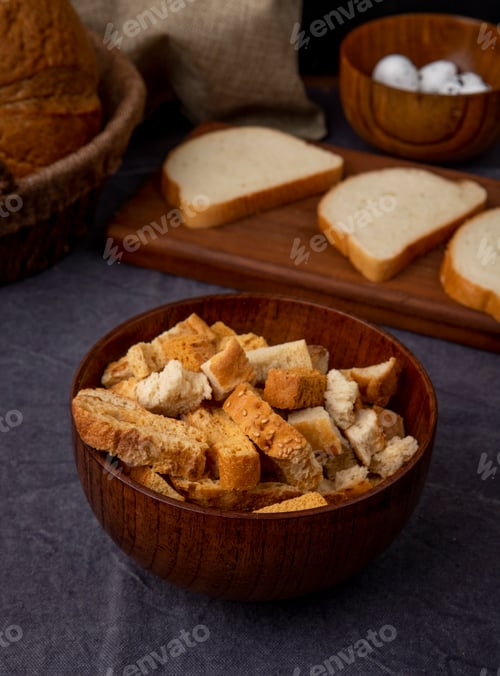 Preview: side view of bowl of bread pieces on maroon background