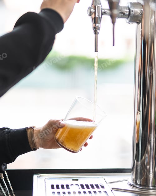 Preview: Vertical shot of a person pouring beer