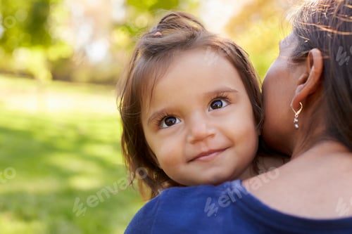 Preview: Mixed race mother holding her daughter, over shoulder view