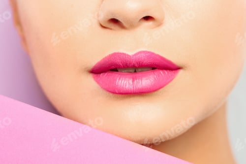 Preview: Young woman wearing beautiful lipstick on color background, closeup
