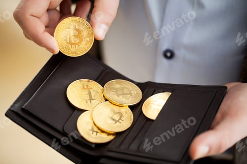 Preview: Golden bitcoin coins in man hands.