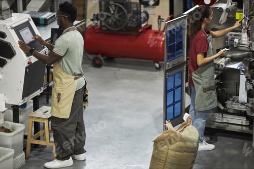 Preview: Two People Operating Machines in Food Factory Workshop