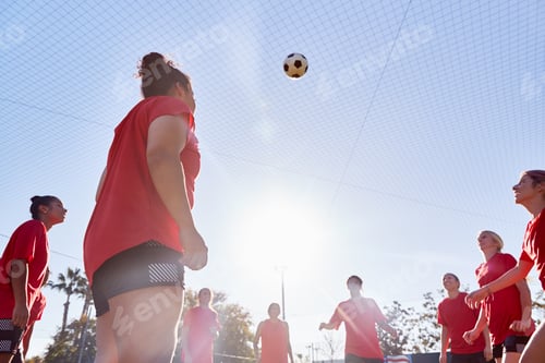 Preview: Womens Football Team Kicking Ball Whilst Training For Soccer Match On Outdoor Astro Turf Pitch