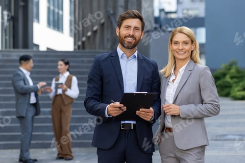 Preview: Portrait of two business partners, business people a man and a woman are smiling and looking at the