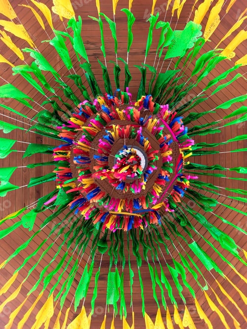 Preview: Colorful decoration made from paper and string at a festival celebration in a community hall