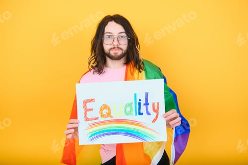 Preview: Hands of gay man holding lgbt banner on rainbow flag background lgbt symbol