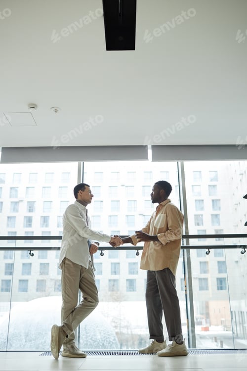 Preview: Wide Angle Shot Of Two People Shaking Hands