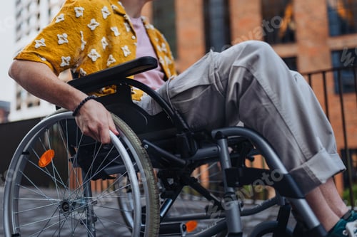 Preview: Close up of young Gen Z boy in a wheelchair in the city. Inclusion, equality, and diversity among