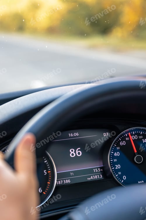 Preview: Steering wheel in a car close up, high speed driving on the road.