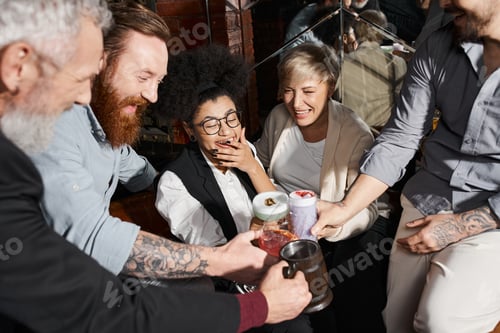 Preview: carefree multiethnic colleagues spending after work time in bar and toasting with alcohol drinks