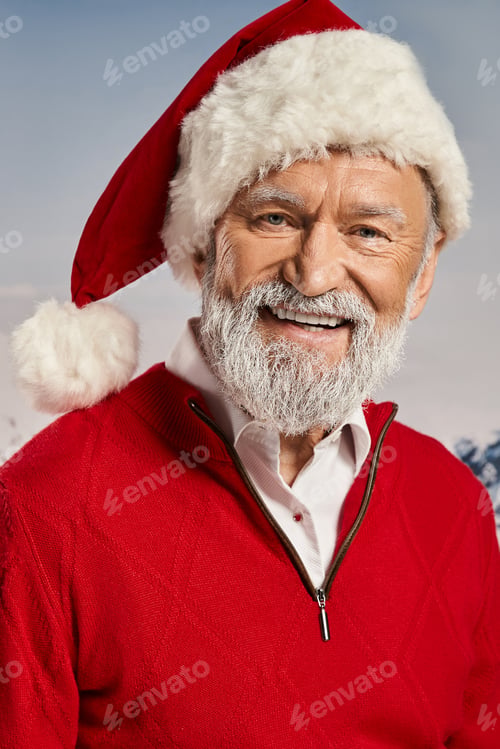 Preview: vertical shot of joyful Santa in red outfit smiling at camera with snowy backdrop, winter concept