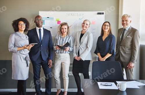 Preview: Team of business people looking at camera