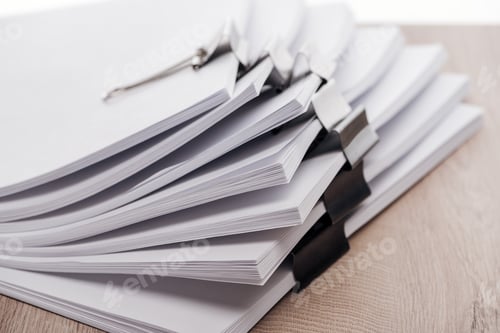 Preview: close up view of stacks of blank paper with metal binder clips