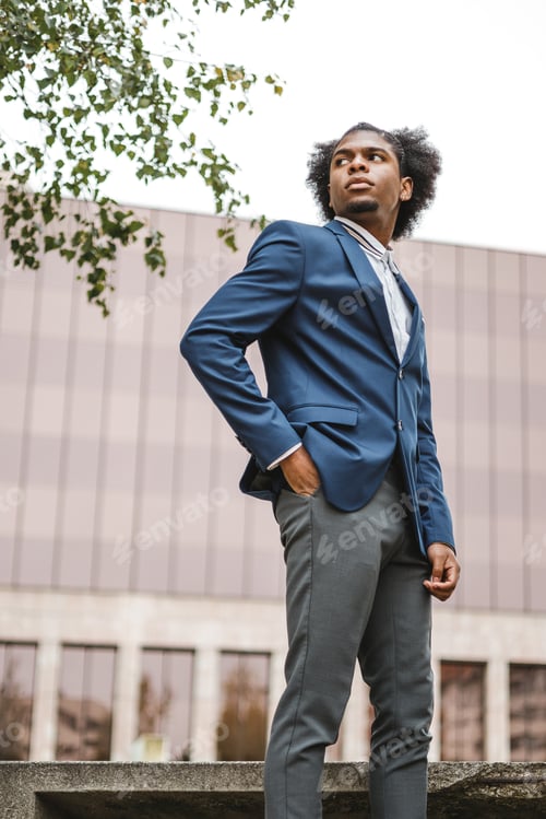 Preview: fashionable portrait of afro businessman in financial district
