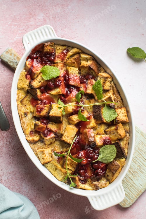 Preview: Homemade bread pudding with jam on a pink concrete background. Selective focus, copy space